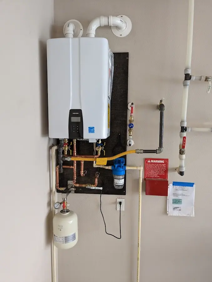 Professional plumber installing copper piping in a Drexel Heights home